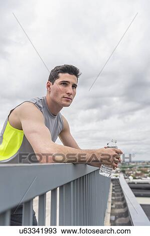 Athlete leaning against railing View Large Photo Image Stock Image - Athlete leaning against railing . Fotosearch
