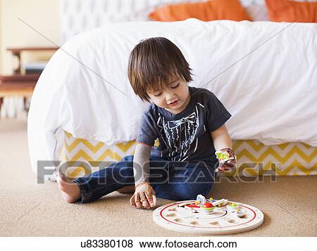 Baby boy (2-3) playing in bedroom View Large Photo Image Stock Photo - Baby boy (2-3) playing in bedroom. Fotosearch