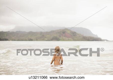 Baby girl (2-3) wading in ocean View Large Photo Image Stock Photograph - Baby girl (2-3) wading in ocean. Fotosearch