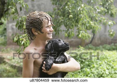 Boy (10-11) with his dog View Large Photo Image Stock Photo - Boy (10-11) with his dog. Fotosearch