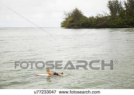 Stock Photo - Boy (6-7) surfing. Fotosearch