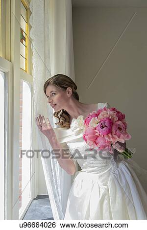 Stock Photograph - Bride looking out window. Fotosearch