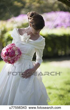 Bride with bouquet of pink flowers View Large Photo Image Stock Image - Bride with bouquet of pink flowers. Fotosearch