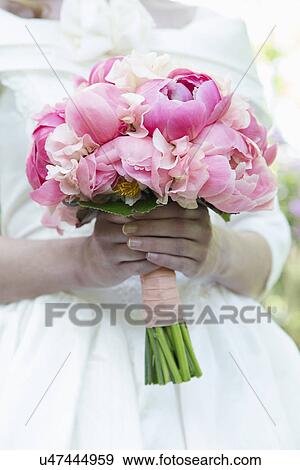 Bride with bouquet of pink flowers View Large Photo Image Stock Photo - Bride with bouquet of pink flowers. Fotosearch