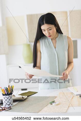 Business woman doing paperwork in office View Large Photo Image Stock Image - Business woman doing paperwork in office. Fotosearch