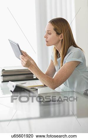 Business woman using tablet pc in office View Large Photo Image Stock Image - Business woman using tablet pc in office. Fotosearch