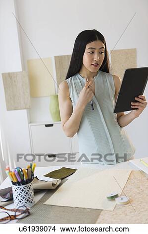 Picture - Business woman using tablet pc. Fotosearch