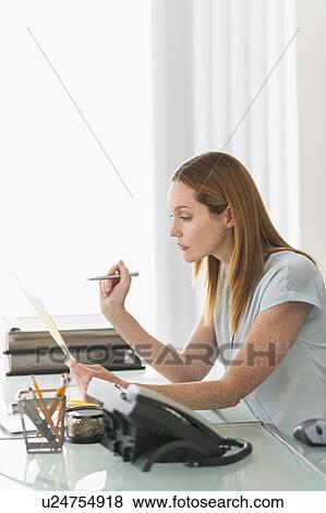 Stock Photo - Business woman working in office. Fotosearch