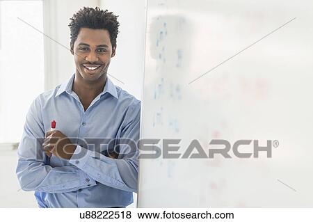 Businessman writing on whiteboard View Large Photo Image Stock Photo - Businessman writing on whiteboard. Fotosearch