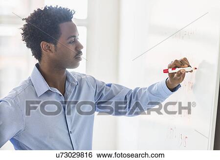 Businessman writing on whiteboard View Large Photo Image Stock Photograph - Businessman writing on whiteboard. Fotosearch