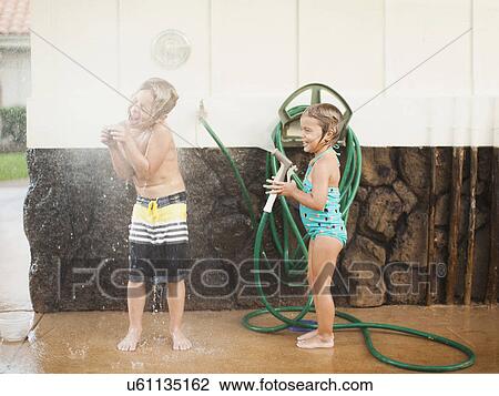 Children (2-3, 6-7) refreshing with garden hose View Large Photo Image Stock Image - Children (2-3, 6-7) refreshing with garden hose. Fotosearch