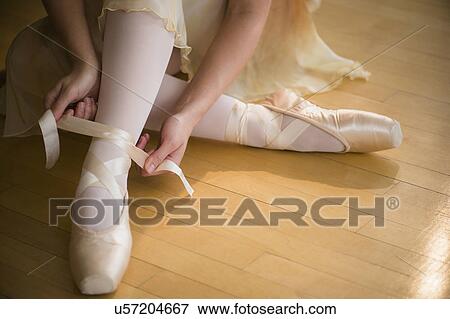Close up of ballet dancer (16-17) tying her ballet shoe View Large Photo Image Stock Photo - Close up of ballet dancer (16-17) tying her ballet shoe. Fotosearch