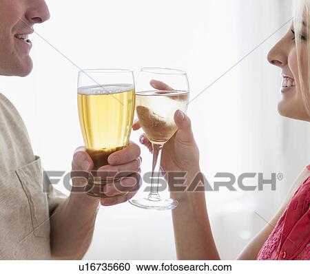 Close-up of couple drinking toast View Large Photo Image Stock Image - Close-up of couple drinking toast. Fotosearch