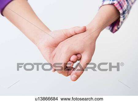Close-up view of friends holding hands View Large Photo Image Picture - Close-up view of friends holding hands. Fotosearch