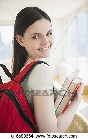Picture - College student with books and backpack. Fotosearch