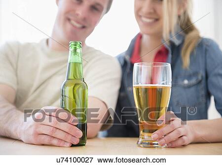 Stock Photo - Couple enjoying beer. Fotosearch