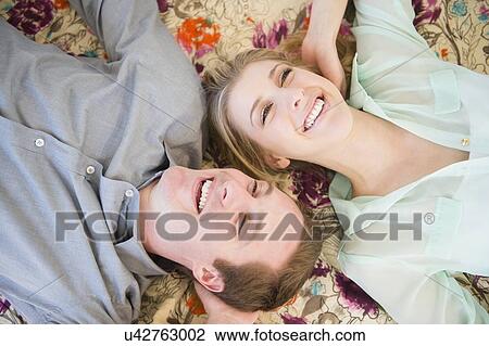Couple lying down View Large Photo Image Stock Image - Couple lying down. Fotosearch