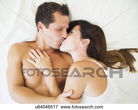 Couple lying on bed View Large Photo Image Stock Photo - Couple lying on bed. Fotosearch