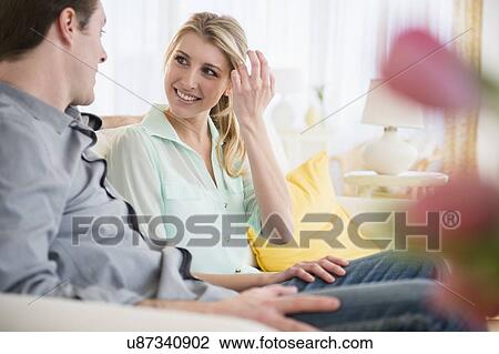 Couple talking on sofa View Large Photo Image Stock Image - Couple talking on sofa. Fotosearch
