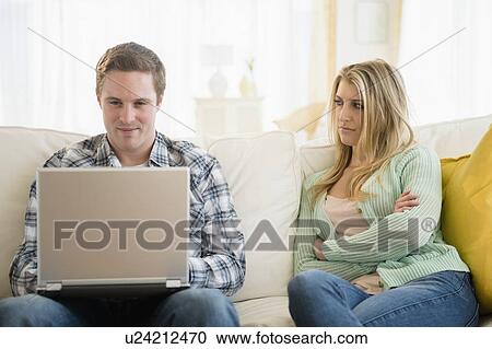 Stock Image - Couple using laptop. Fotosearch