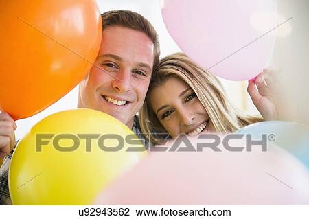 Couple with colorful balloons View Large Photo Image Stock Image - Couple with colorful balloons. Fotosearch