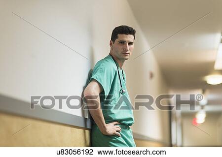 Stock Image - Doctor standing in hallway. Fotosearch
