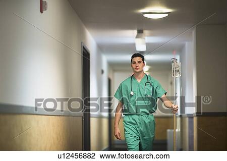 Doctor walking in hospital corridor View Large Photo Image Stock Image - Doctor walking in hospital corridor. Fotosearch