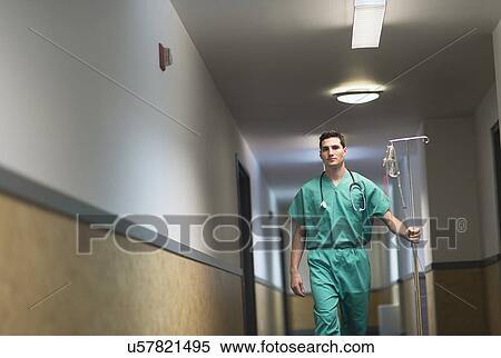 Stock Photography - Doctor walking in hospital corridor. Fotosearch