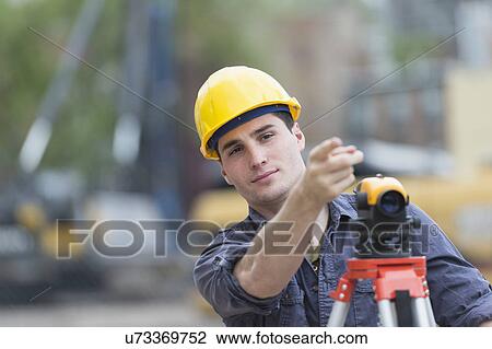 Engineer using theodolite View Large Photo Image Stock Image - Engineer using theodolite. Fotosearch