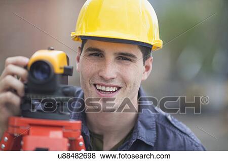 Stock Photo - Engineer using theodolite. Fotosearch