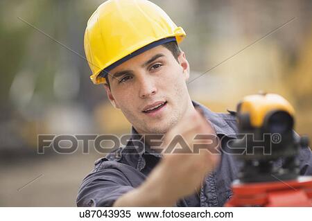 Stock Photography - Engineer using theodolite. Fotosearch