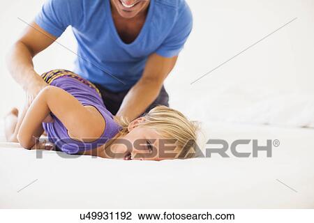 Stock Image - Father playing with daughter (2-3). Fotosearch