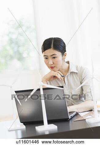 Female engineer working on laptop View Large Photo Image Stock Photograph - Female engineer working on laptop. Fotosearch