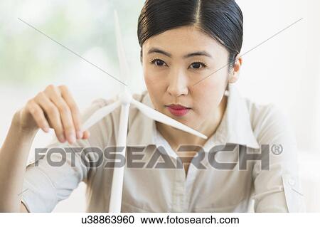 Female engineer working on model of wind turbine View Large Photo Image Stock Image - Female engineer working on model of wind turbine. Fotosearch