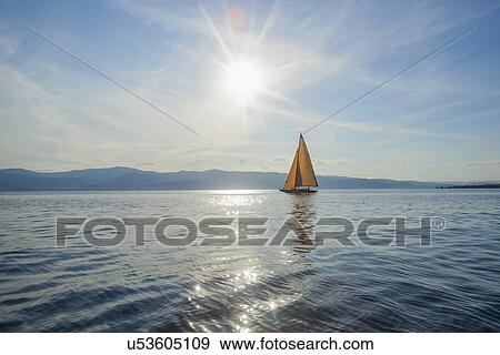 Stock Photo - Flathead Lake, Tranquil scene with sailboat. Fotosearch