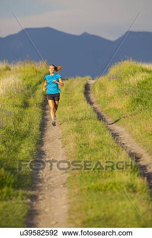 Front view of young woman jogging View Large Photo Image Stock Image - Front view of young woman jogging. Fotosearch