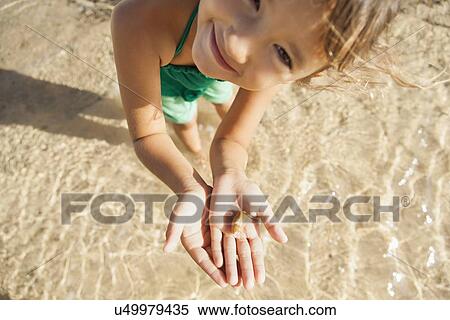 Girl (6-7) playing on beach View Large Photo Image Stock Photography - Girl (6-7) playing on beach. Fotosearch