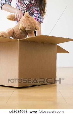 Girl (8-9) packing teddy bear to carton box View Large Photo Image Stock Photo - Girl (8-9) packing teddy bear to carton box. Fotosearch