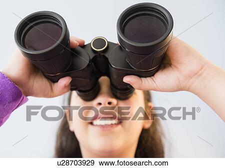 Stock Photo - Girl (8-9) using binoculars. Fotosearch
