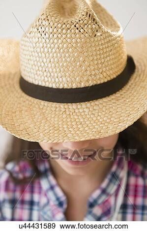 Stock Photo - Girl (8-9) wearing straw hat. Fotosearch