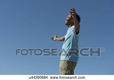 Happy man against clear sky View Large Photo Image Picture - Happy man against clear sky. Fotosearch