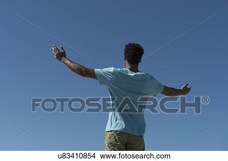 Happy man against clear sky View Large Photo Image Picture - Happy man against clear sky. Fotosearch