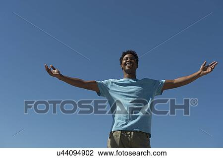Happy man against clear sky View Large Photo Image Stock Image - Happy man against clear sky. Fotosearch