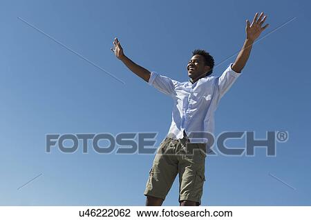 Happy man against clear sky View Large Photo Image Stock Image - Happy man against clear sky. Fotosearch