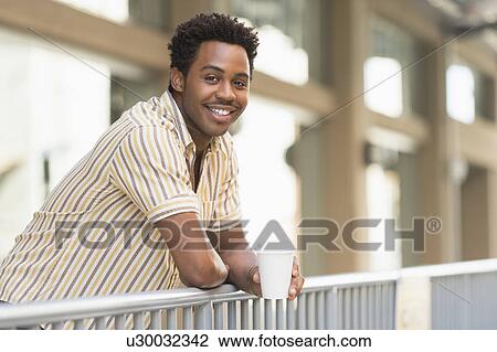 Man drinking coffee outdoors View Large Photo Image Stock Image - Man drinking coffee outdoors. Fotosearch