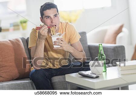 Man eating take out meal and watching television View Large Photo Image Stock Photography - Man eating take out meal and watching television. Fotosearch
