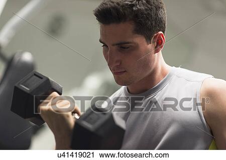 Stock Image - Man lifting dumbbells. Fotosearch
