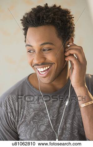 Stock Image - Man listening to the music. Fotosearch