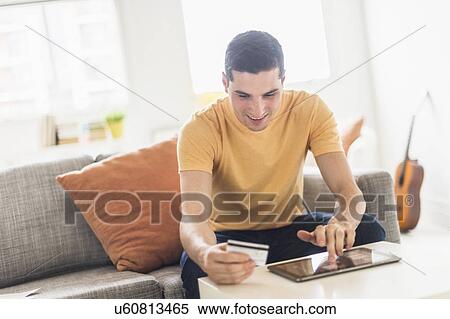 Stock Photography - Man online shopping . Fotosearch