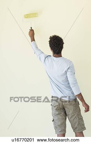 Stock Image - Man painting wall. Fotosearch